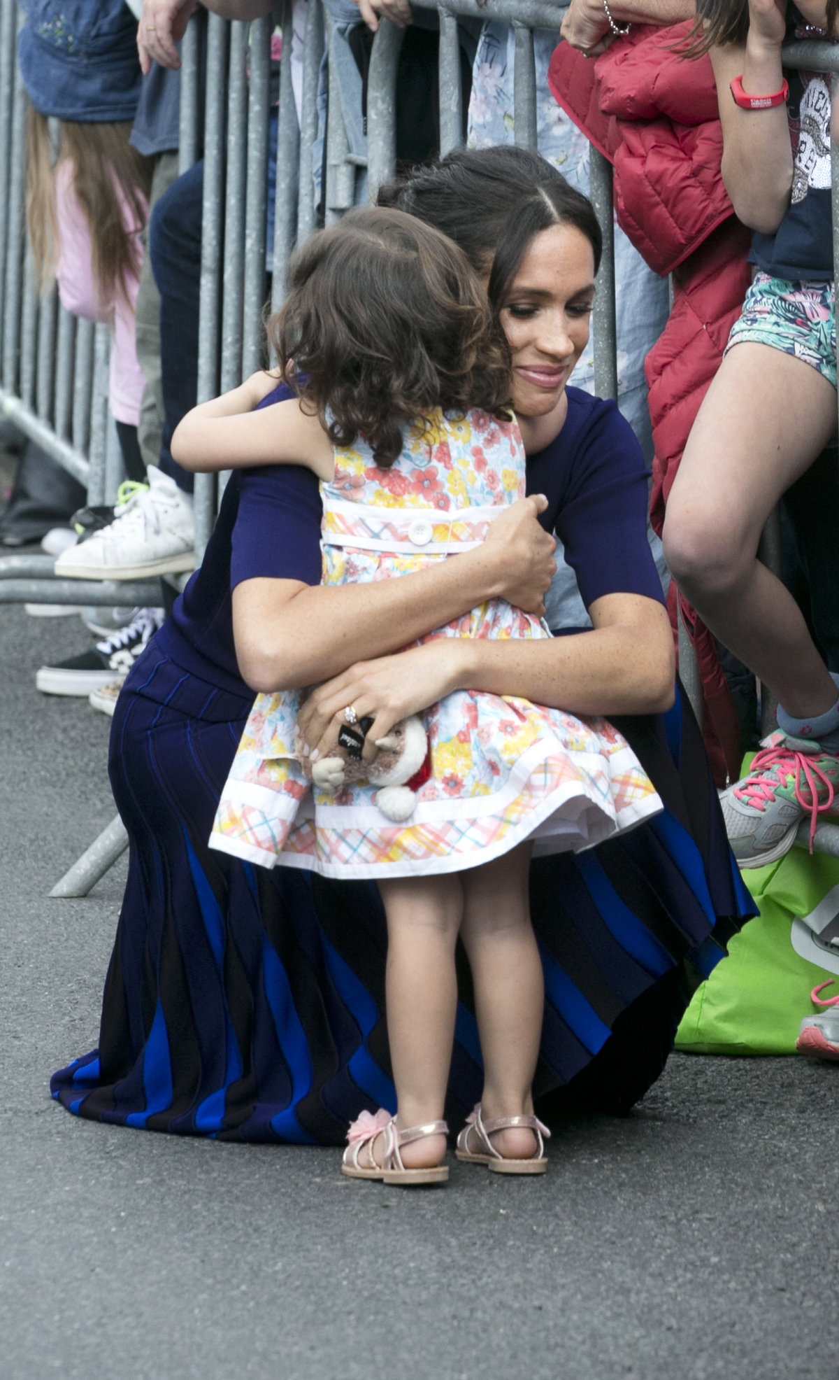Meghan Markle umarmt ein kleines Kind