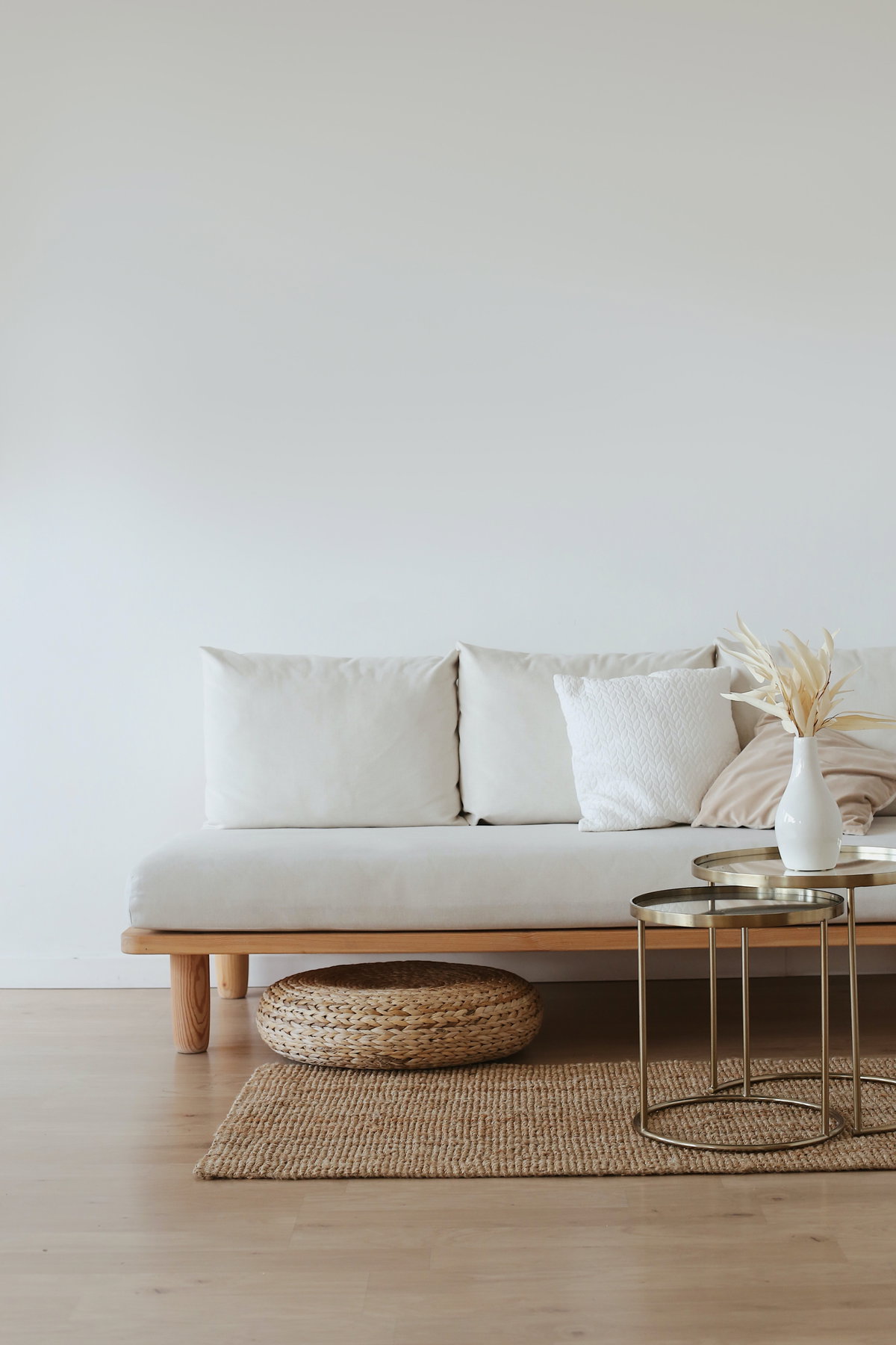 Beiges Sofa auf einem Jute-Teppich mit Deko