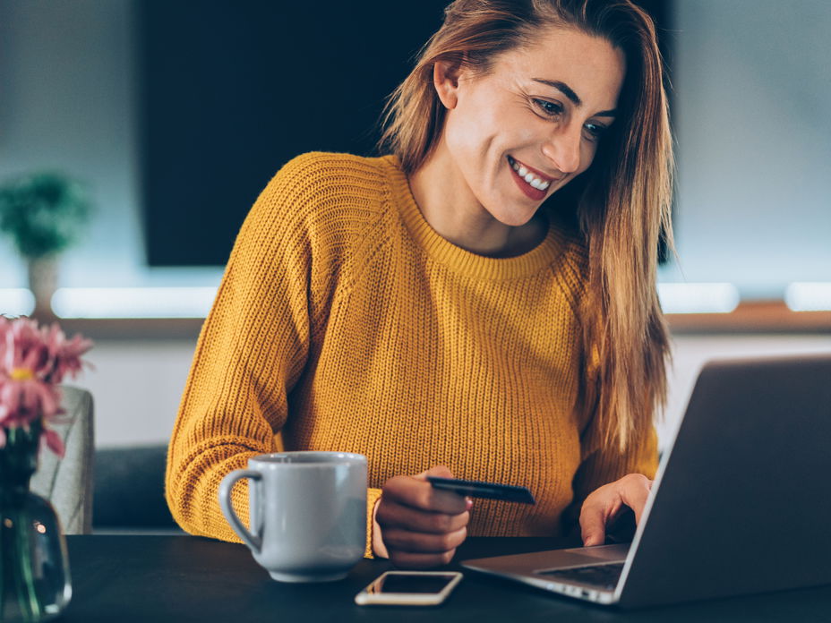Frau sitzt am Laptop beim Onlineshopping