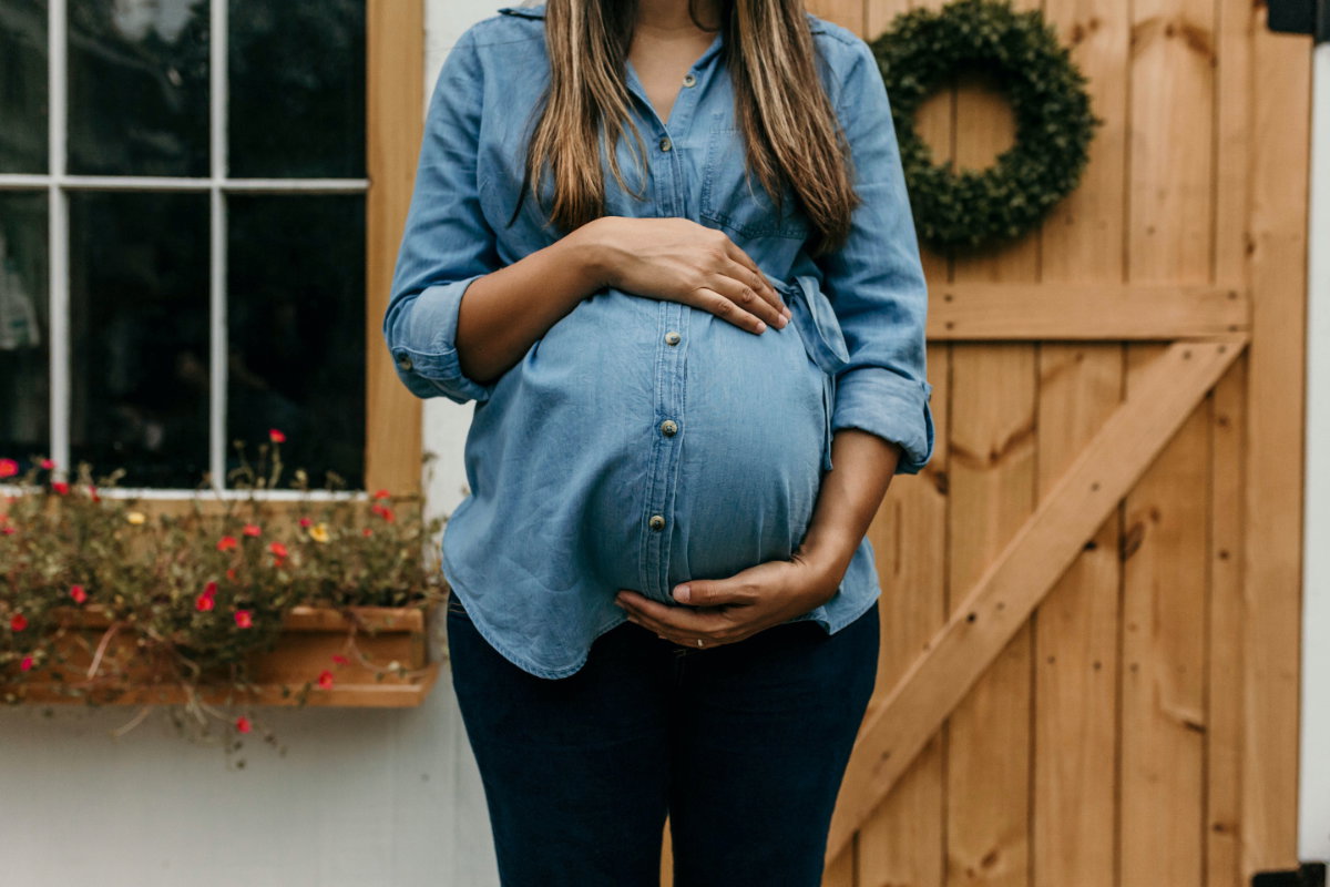 Schwangere Frau hält ihren Bauch