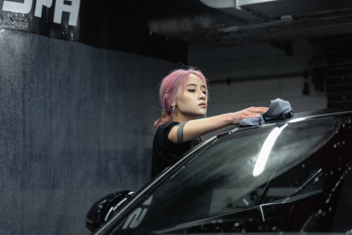 Frau putzt Auto