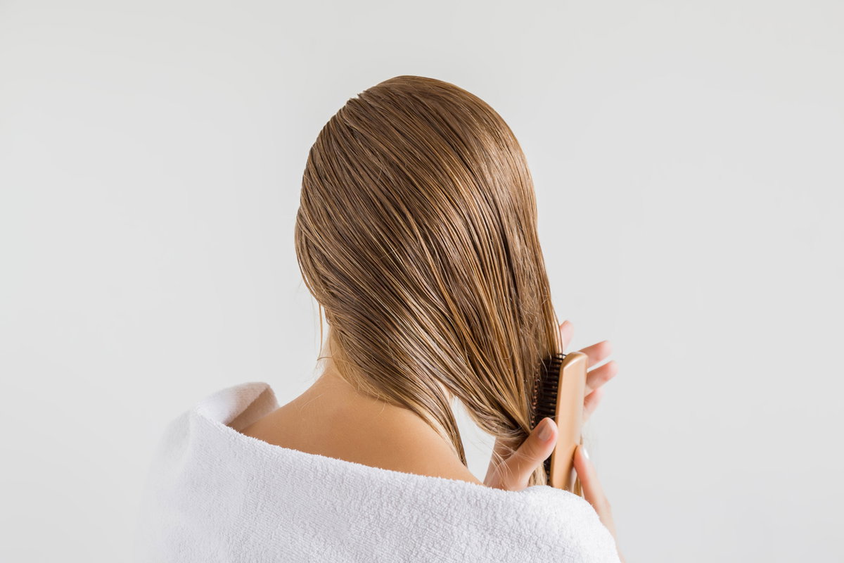 Frau pflegt blondierte Haare