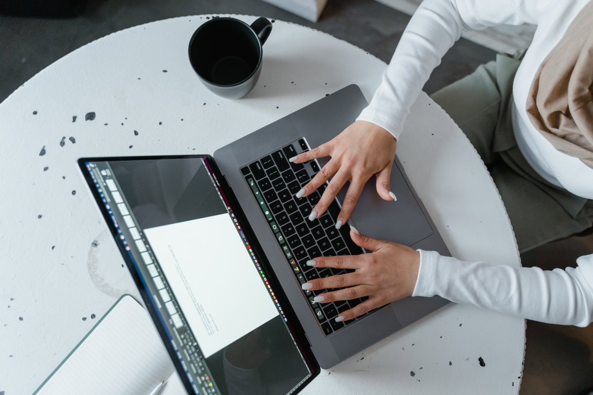 Person tippt auf Laptop