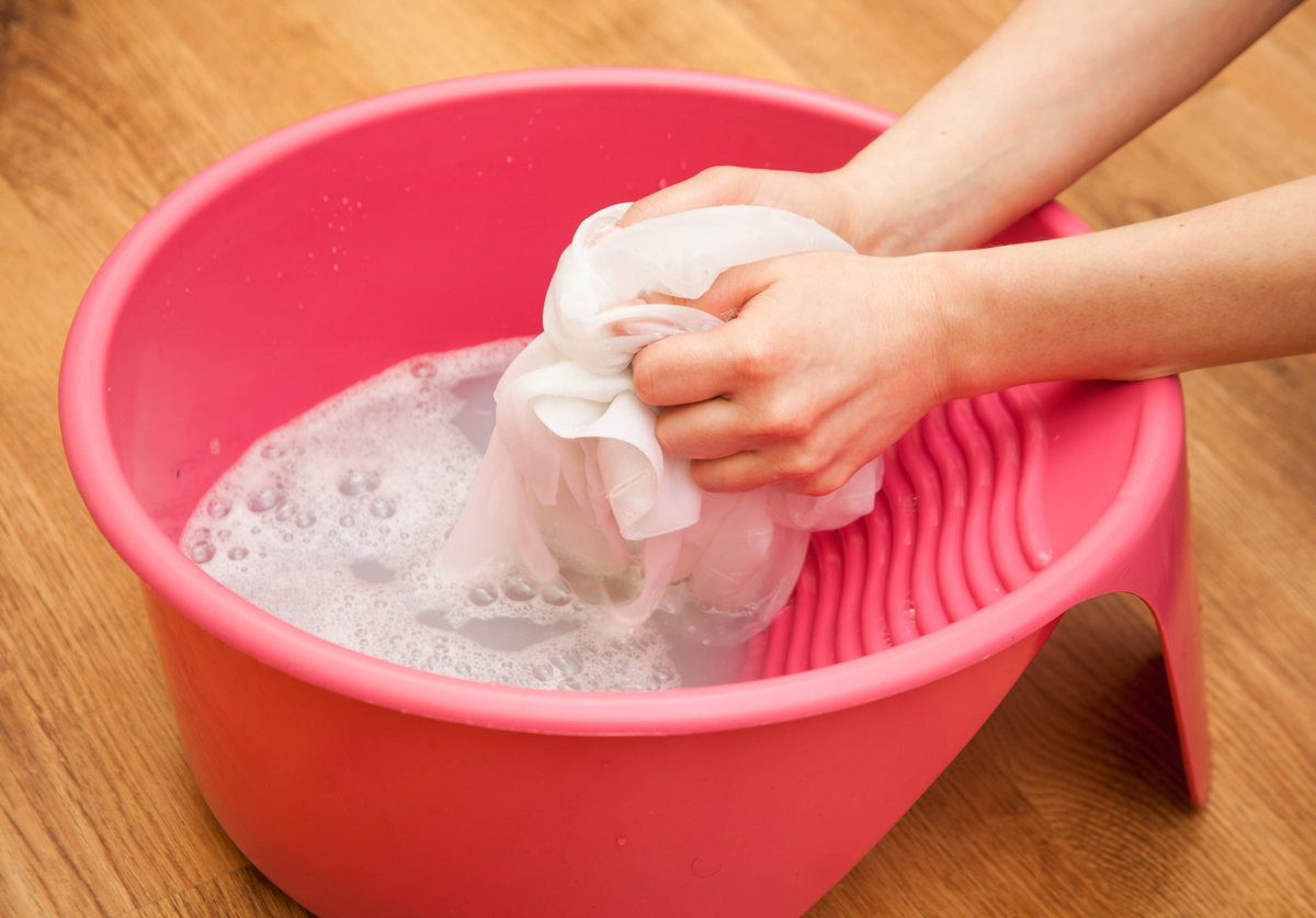 Wäsche wird in Schüssel gewaschen