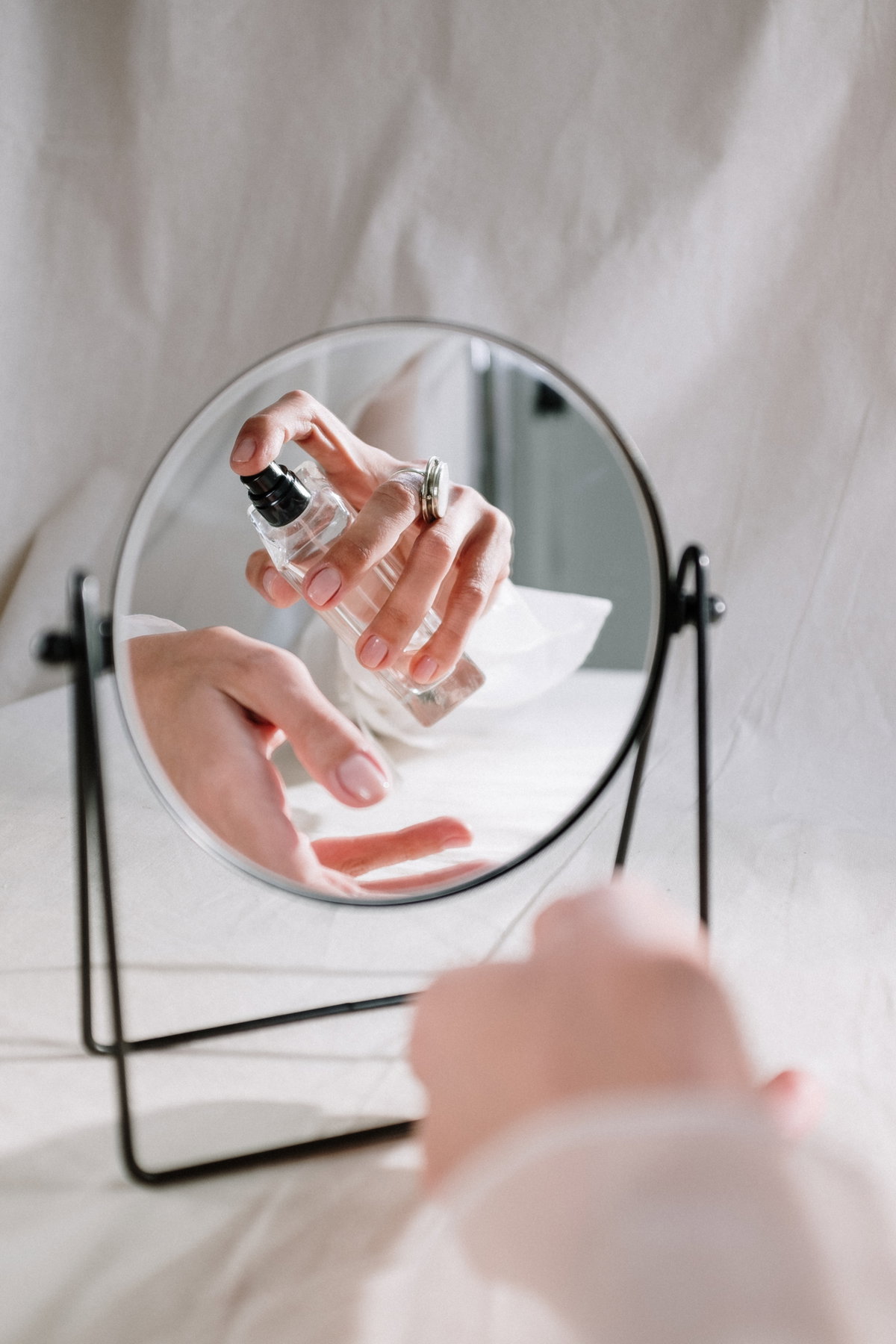Frau sprüht Parfum auf