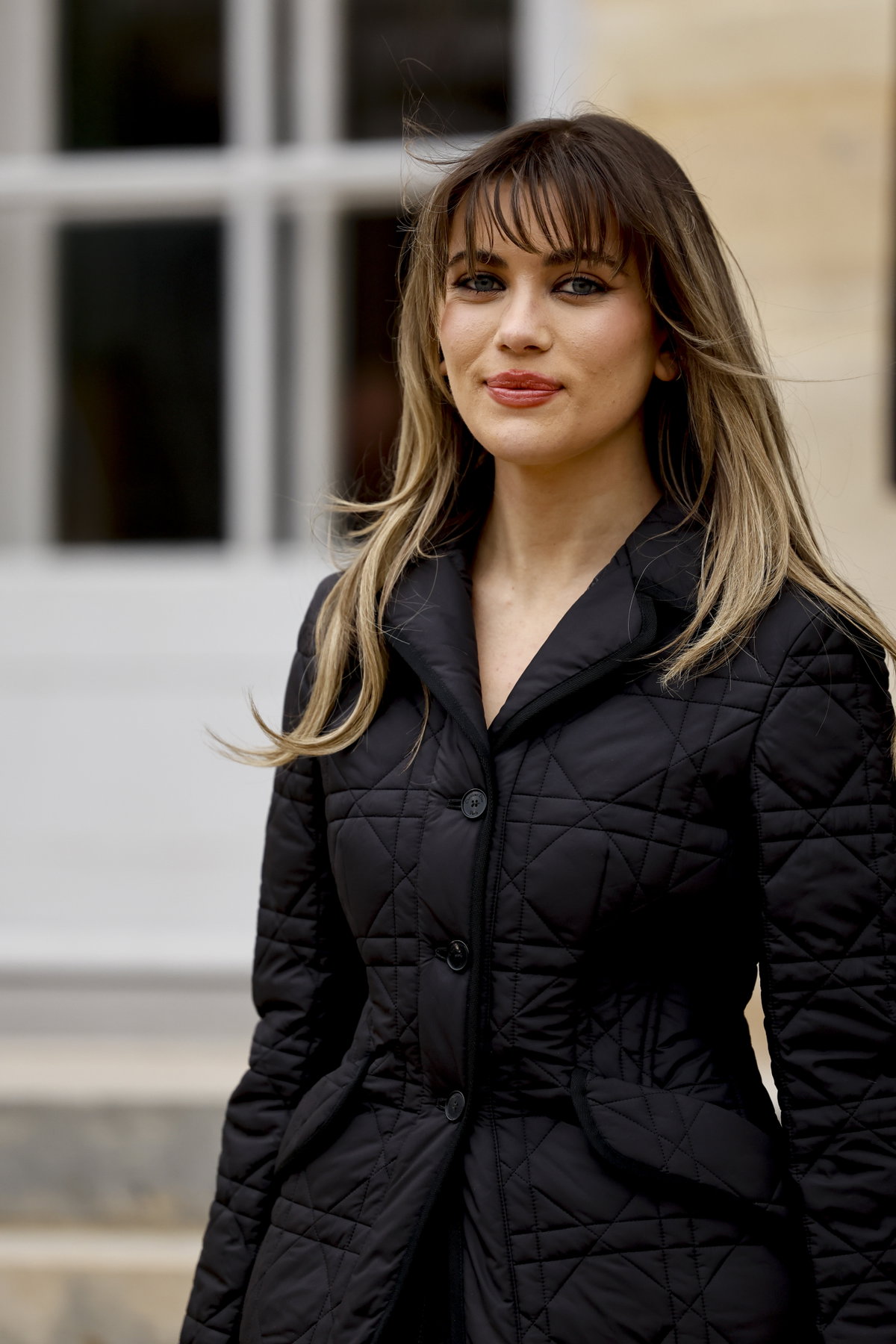 Frau trägt schwarze Jacke und Fox Cut auf Paris Fashion Week