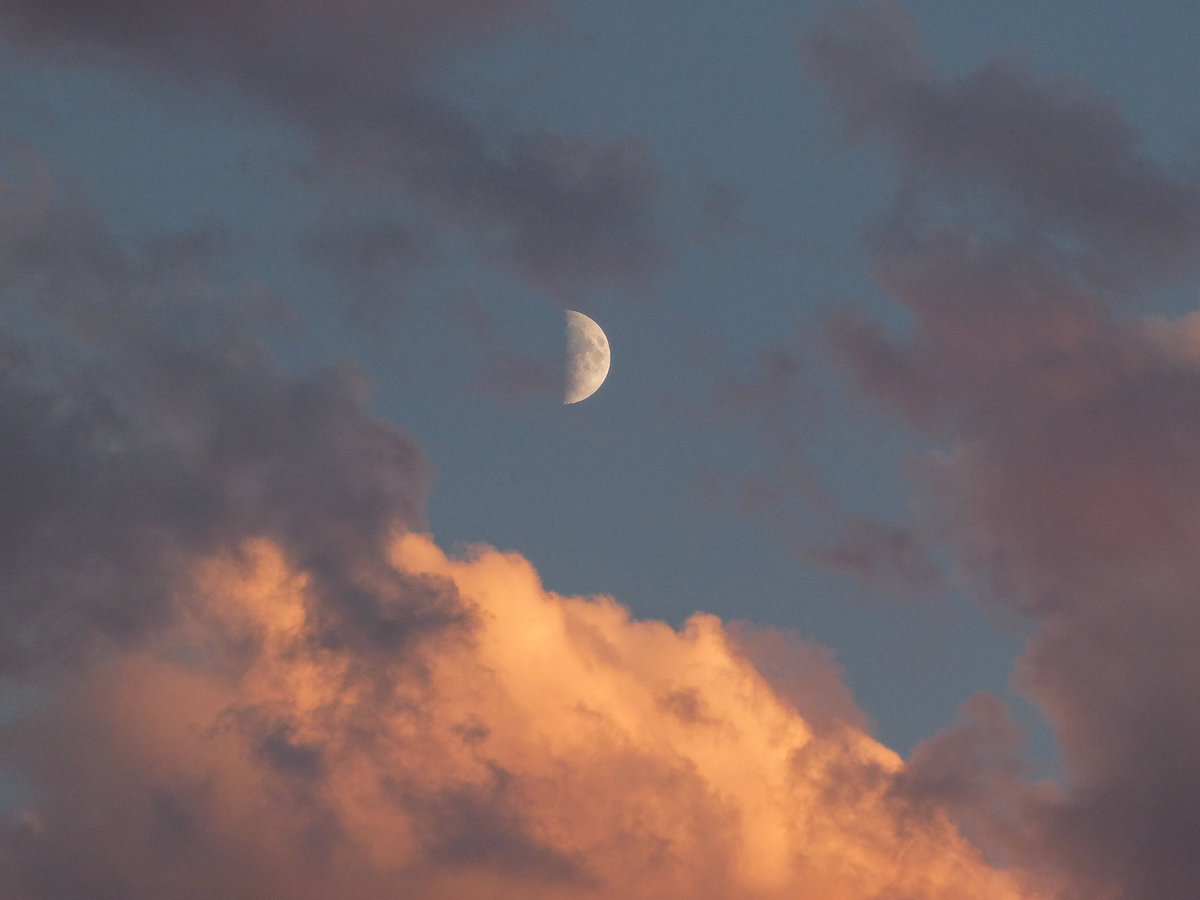 Mond am Himmel zwischen Wolken