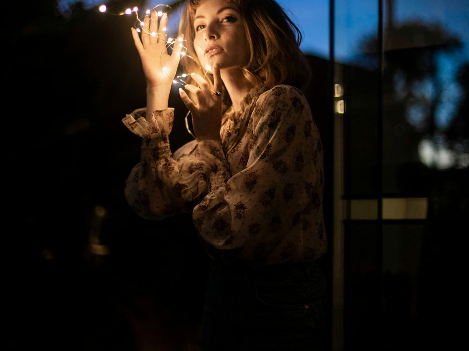 Frau hält Lichterkette in der Hand