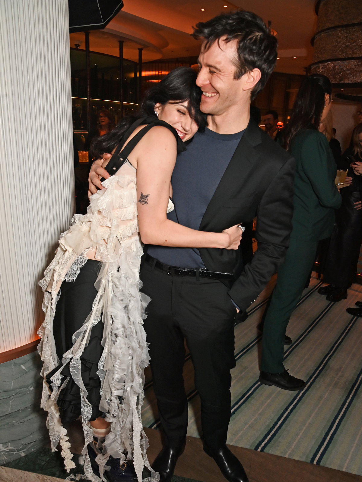 Luke Thompson und Harriet Cains bei einer Veranstaltung Arm in Arm.