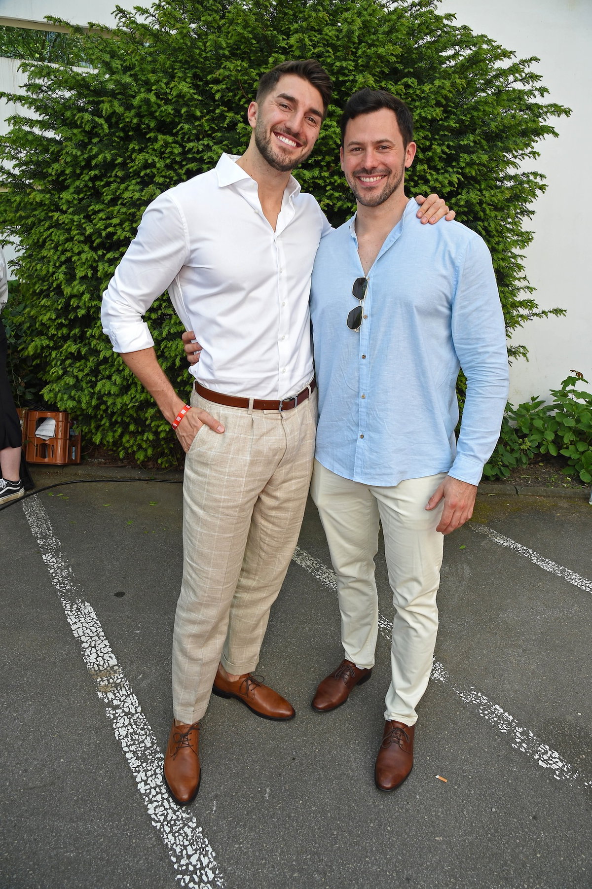 Dennis Gries und Sebastian Klaus in Hemd vor einem grünen Busch.